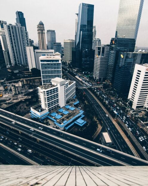 Aerial view of Jakarta cityscape with modern buildings and busy highways in Indonesia
