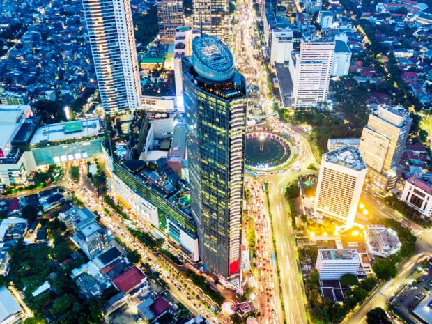 Aerial view of Jakarta cityscape with high rise buildings and busy traffic at night
