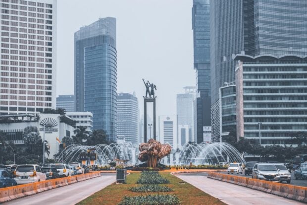 Modern skyscrapers and a busy traffic roundabout in Jakarta cityscape