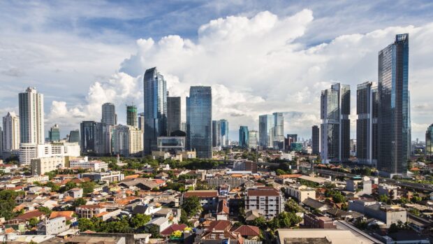 Modern Jakarta skyline with tall buildings under a cloudy sky