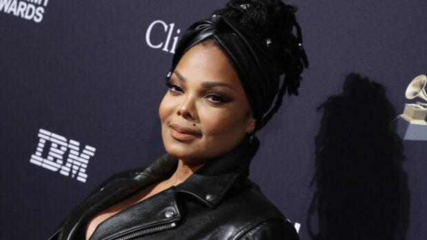 Janet Jackson wearing a black leather jacket and head wrap at an awards event