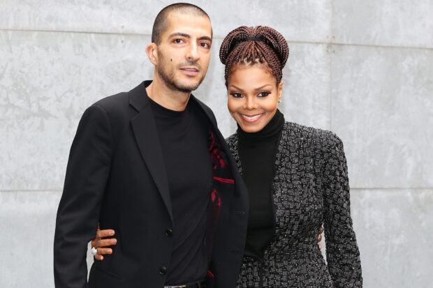Janet Jackson posing with a man wearing black outfits in a formal setting