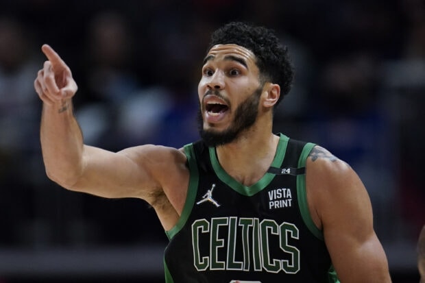 Jayson Tatum pointing during a basketball game in a Celtics jersey