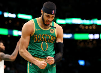 Jayson Tatum celebrates with clenched fists during a basketball game for Boston