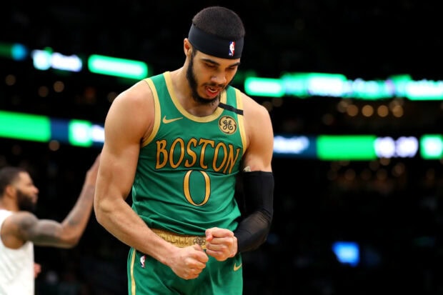 Jayson Tatum celebrates with clenched fists during a basketball game for Boston
