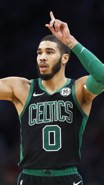 Jayson Tatum in Celtics uniform signaling during a basketball game
