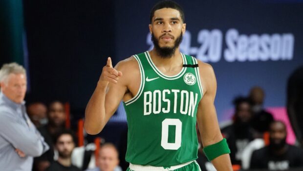 Jayson Tatum is wearing a Boston Celtics basketball jersey during a game