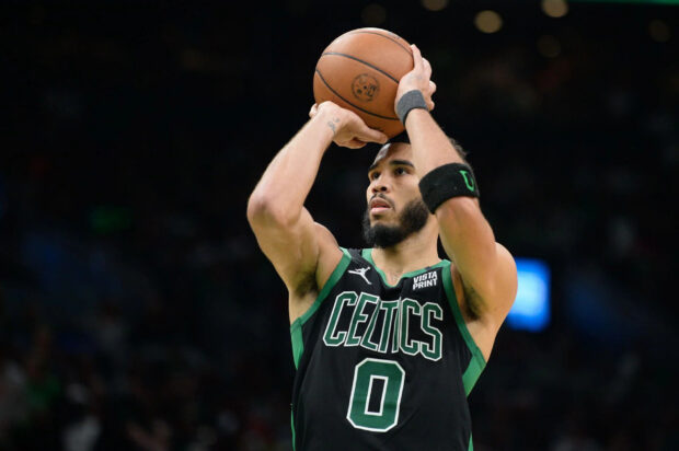 Jayson Tatum preparing to shoot a basketball during an intense game moment