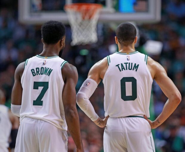Jayson Tatum standing alongside teammate Brown during a basketball game