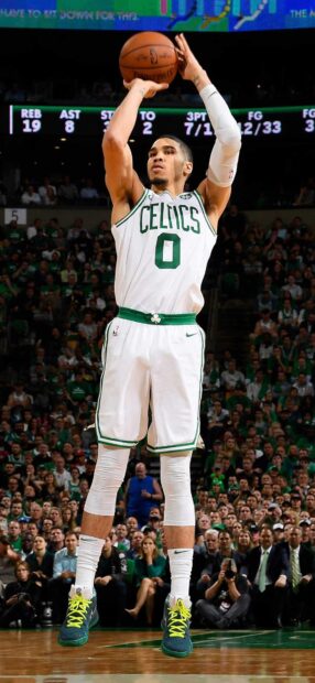 Jayson Tatum preparing to shoot a basketball during an intense game
