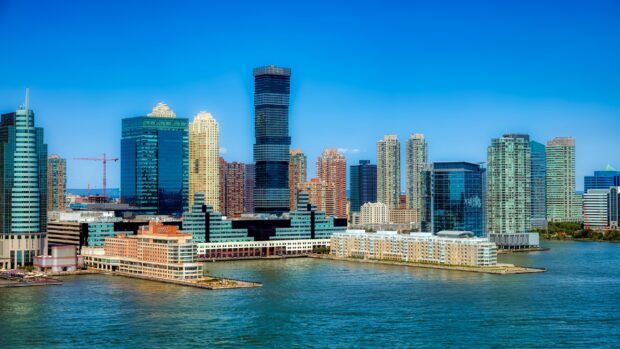 Modern Jersey City skyline with tall buildings near the waterfront on a clear day