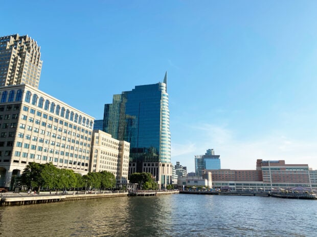 Modern Jersey City skyline with waterfront and high rise buildings on a clear day