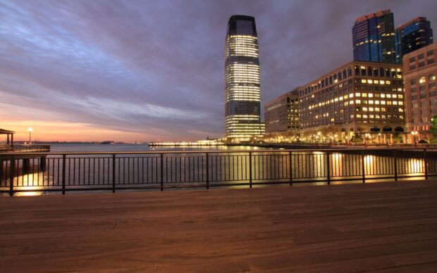 View of Jersey City skyline at dusk with waterfront and illuminated buildings