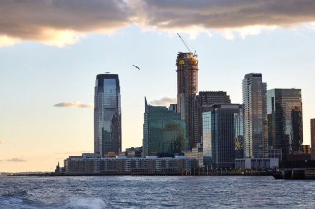 Jersey City skyline with modern skyscrapers reflecting sunlight near the waterfront