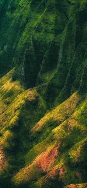 Lush Kauai landscape with steep green ridges and vibrant vegetation