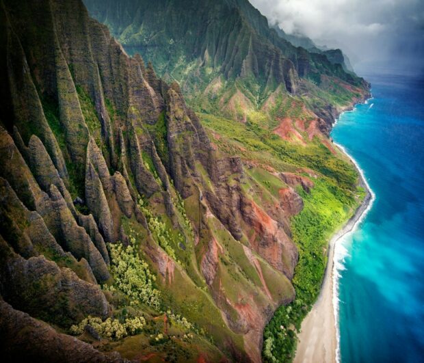 A breathtaking Kauai landscape with dramatic cliffs and vibrant greenery along the coastline