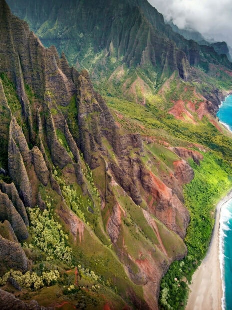 Lush Kauai cliffs and coastline with vibrant greenery and dramatic peaks