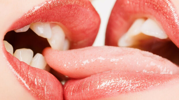 Close up of lips and tongue showing kiss action with kiss lips
