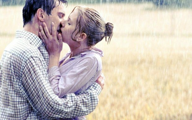 A romantic kiss between a couple in the rain showing deep love and passion