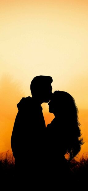 Couple kiss silhouette against sunset with romantic kiss gesture