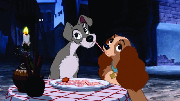 The iconic Lady and Tramp sharing a romantic spaghetti dinner in a charming alley