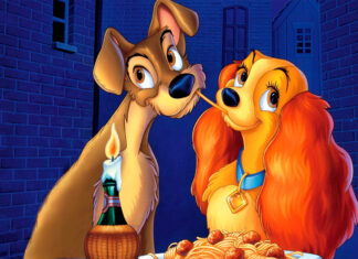 Lady And The Tramp sharing spaghetti in a romantic scene with candlelight in an alley