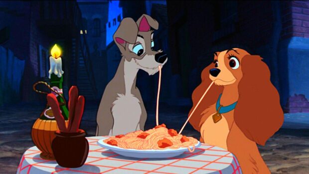 Lady and the tramp sharing spaghetti in a romantic scene from the movie Lady and the Tramp