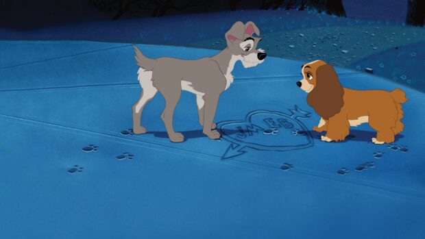 Two Lady And The Tramp characters standing on a blue surface with a carved heart and initials