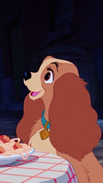 Lady from Lady And The Tramp enjoying a plate of spaghetti on a table