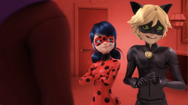 A ladybug character standing confidently next to a black cat character in a red room