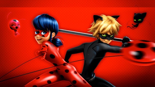 Animated ladybug character and a cat themed superhero posing together on a red background