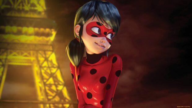 A ladybug character wearing a red suit with black dots stands near a lit yellow tower in the background