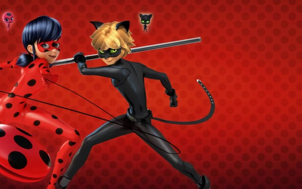 Animated ladybug and cat superhero characters in action pose on a red dotted background