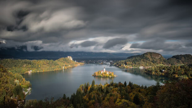Lake Bled surrounded by autumn forest and cloudy sky in high resolution 2K