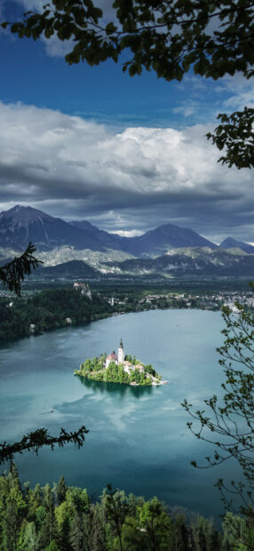 Serene Lake Bled island with church surrounded by mountains and lush greenery