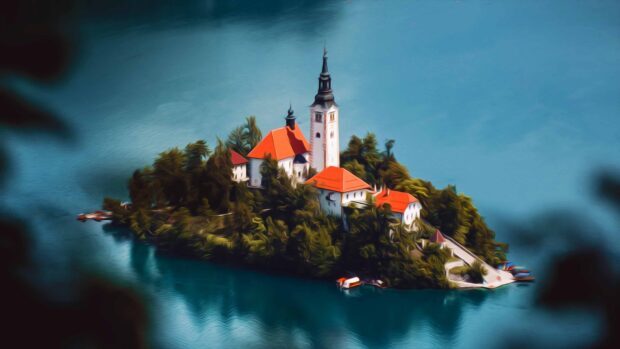 Aerial view of Lake Bled island with red roofed buildings surrounded by water and trees