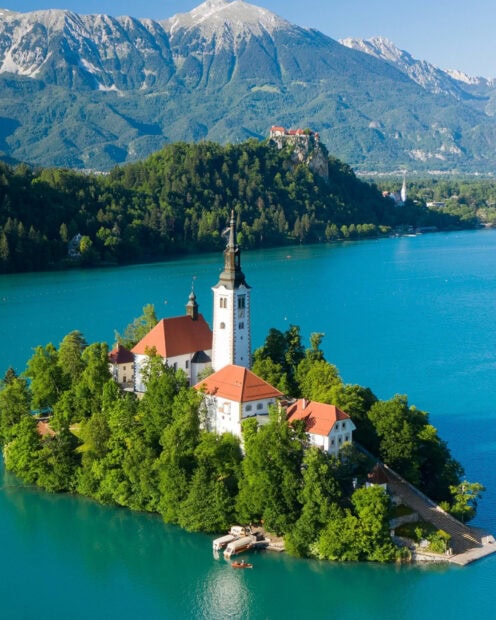 Lake Bled with the church on the island surrounded by clear turquoise water and lush green trees