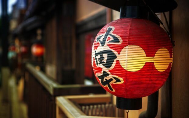 Traditional Japanese lanterns glowing softly in a rustic wooden setting