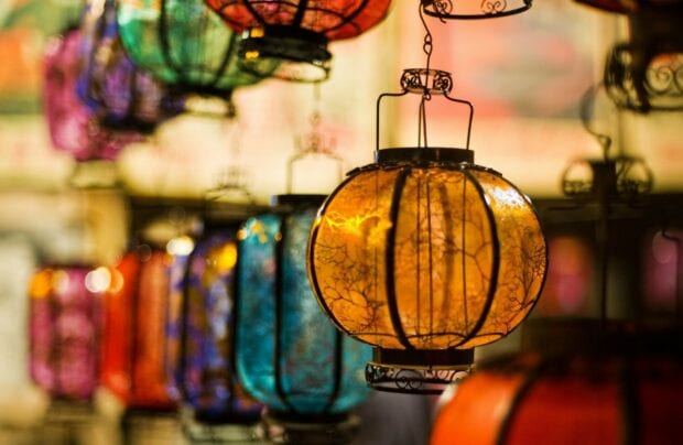 Vibrant lanterns glowing in warm colors with intricate designs in a festive setting