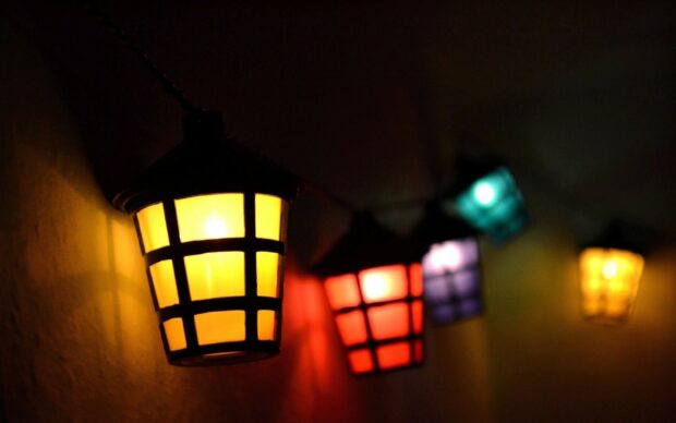 Colorful lanterns glowing warmly in the dark hallway with vivid lanterns