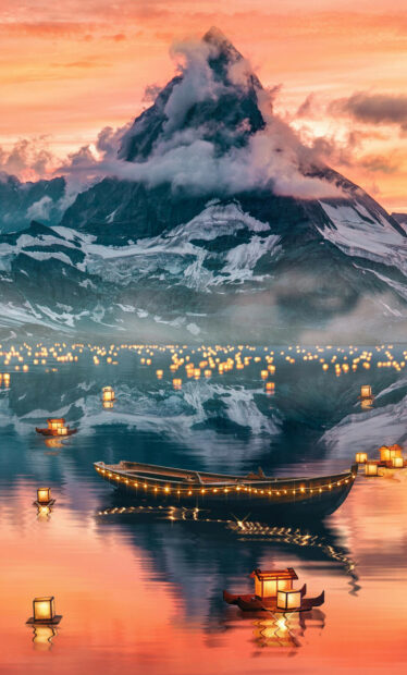 Floating lanterns glowing on serene lake with mountain backdrop at sunset