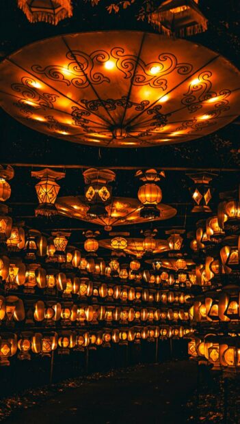 Traditional lanterns hanging in rows creating a warm glowing atmosphere at night