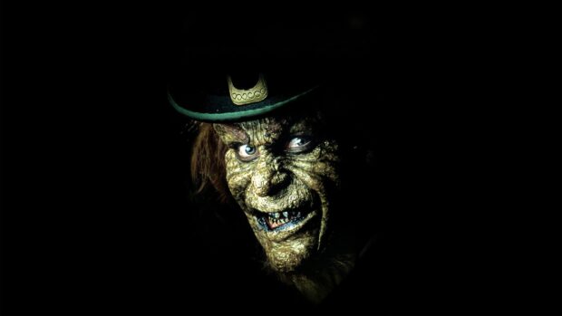 A creepy leprechaun with wrinkled skin and a green hat staring intensely