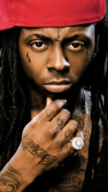 Lil Wayne close up with tattoos and rings on his hand