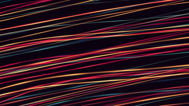 Colorful lines create vibrant abstract pattern on dark background