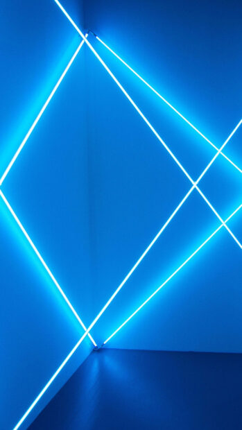 Blue neon lines forming geometric shapes in a corner creating a glowing lines pattern