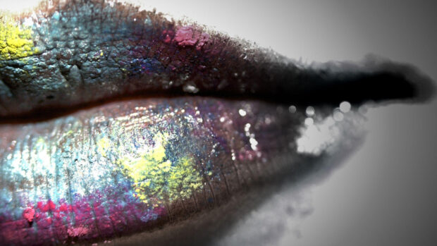 Close up of lipstick with vibrant colors on textured lips
