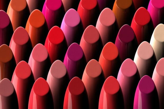 Close up of colorful lipstick collection in various shades arranged neatly