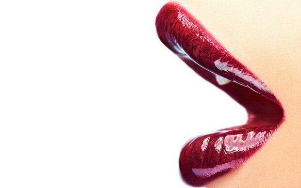 Close up of glossy lipstick on lips showing rich texture and shine