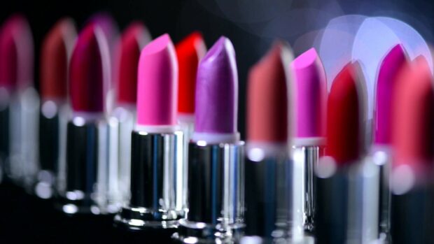 A row of colorful lipstick tubes with vibrant shades and metallic silver cases in focus
